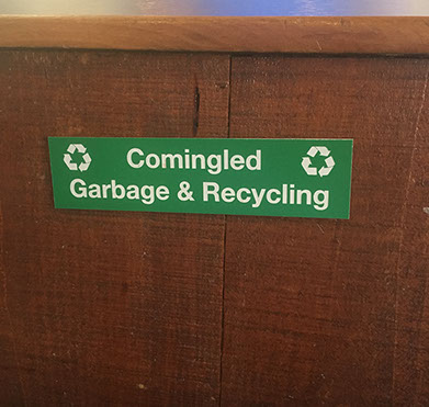 Green acrylic piece with white letters engraving sign